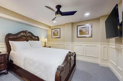 a bedroom with a bed and a flat screen tv at Centrally Located Home by Holyoke Medical Center in Holyoke