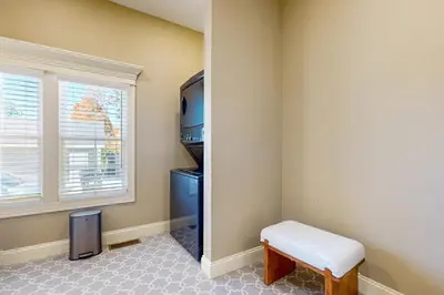 a small room with a stool and a window at Centrally Located Home by Holyoke Medical Center in Holyoke