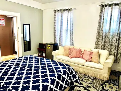 a bedroom with a bed and a couch at 3 Bedroom Apt in LIC, 2 Stops to Manhattan! in Roosevelt Island
