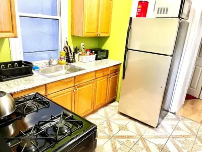 a kitchen with a refrigerator and a stove at 3 Bedroom Apt in LIC, 2 Stops to Manhattan! in Roosevelt Island