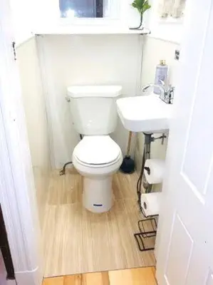 a bathroom with a white toilet and a sink at 3 Bedroom Apt in LIC, 2 Stops to Manhattan! in Roosevelt Island
