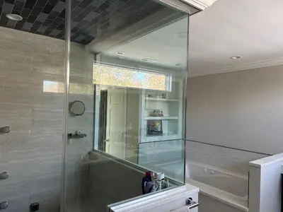 a bathroom with a shower with a mirror and a sink at Luxury Private Estate, 5BR 6BA, close to MetLife with ample parking in Green Village