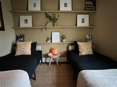 a living room with two couches and a table at Stylish Mission-Style Home on Park in Jersey City, NJ in Jersey City