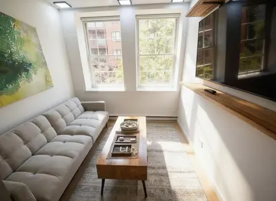 a living room with a couch and a coffee table at Bright Luxury 3-Bedroom Apartment in East Village in New York
