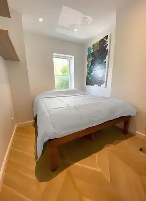 a large bed in a room with a window at Bright Luxury 3-Bedroom Apartment in East Village in New York