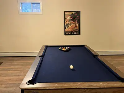 a pool table with a ball on top of it at Stunning 5BR at Hunter and Windham w Oversized Deck, 5 Acres, and Mountain View in Jewett