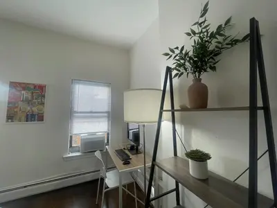 a room with a desk with a computer and a lamp at Perfect for Extended Stay 1B1B Apt 15 Mins to NYC in Jersey City
