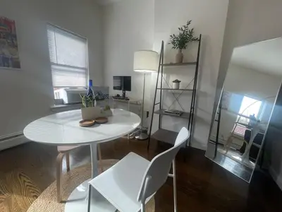 a white table and chairs in a room at Perfect for Extended Stay 1B1B Apt 15 Mins to NYC in Jersey City