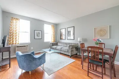 a living room with a couch and a table at Stunning 3 Bed Fully Furnished Apt in New York
