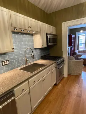 a kitchen with white cabinets and a sink at Downtown 3BR duplex full kitchen parking off i-787 in Albany