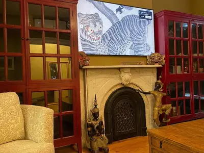 a living room with a large screen above a fireplace at Downtown 3BR duplex full kitchen parking off i-787 in Albany