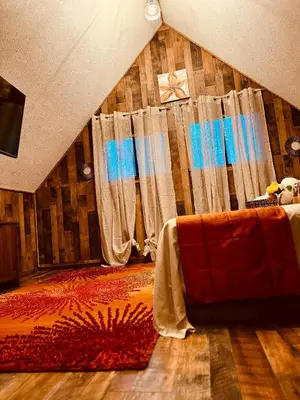 a living room with a couch and a curtain at Cozy Cabin in Tobyhanna