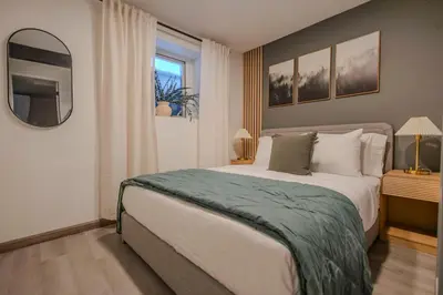 a bedroom with a large bed and a window at Summit Home - The Ultimate Summit of Style for 12 in Tobyhanna