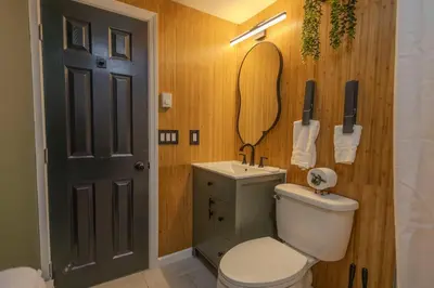 a bathroom with a toilet and a sink and a phone at Summit Home - The Ultimate Summit of Style for 12 in Tobyhanna