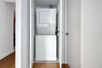 a microwave oven sitting on top of a refrigerator at Chelsea 1br w doorman wd nr West Village NYC-1385 in New York