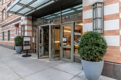 a building with two large potted plants in front of it at Chelsea 1br w doorman wd nr West Village NYC-1385 in New York