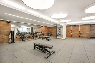 a gym with dumbbells and a row of mirrors at Chelsea 1br w doorman wd nr West Village NYC-1385 in New York