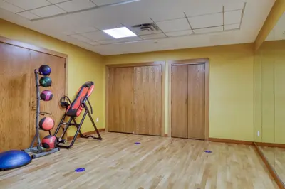 an empty room with a gym with exercise equipment at Blueground East Harlem pool nr Central Park NYC-687 in New York
