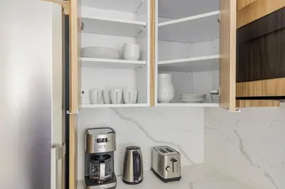 a kitchen with a coffee maker in a cupboard at Blueground Murray Hill washer nr Bryant Park NYC-1870 in New York