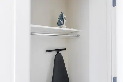 an open door with a towel rack and a black tie at Blueground Southside rooftop nr McCarren Park NYC-2012 in Brooklyn