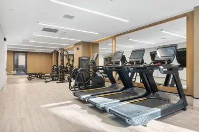 a gym with several treadmills and elliptical machines at Blueground Southside rooftop nr McCarren Park NYC-2012 in Brooklyn