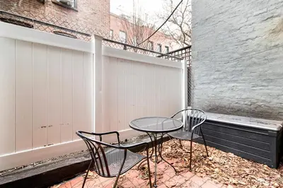 two chairs and a table on a balcony at Blueground West Village terrace nr Hudson River Park NYC-2123 in New York