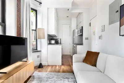 a living room with a couch and a flat screen tv at Blueground West Village terrace nr Hudson River Park NYC-2123 in New York