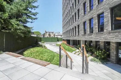 a building with a walkway next to a building at Blueground Williamsburg rooftop nr Domino Park NYC-2204 in Brooklyn