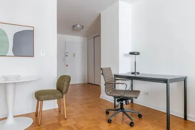 an office with a desk and two chairs in a room at Blueground Yorkville pool nr Central Park NYC-2218 in New York