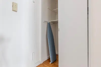a closet with a blue surfboard in it at Blueground Yorkville pool nr Central Park NYC-2218 in New York