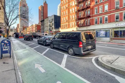a van parked on the side of a city street at Blueground Yorkville pool nr Central Park NYC-2218 in New York
