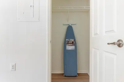 a surfboard leaning against a wall next to a door at Blueground Hudson Exchange pool nr Liberty Park NYC-2222 in New York