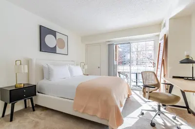 a bedroom with a bed and a desk and a window at Blueground Hudson Exchange pool nr Liberty Park NYC-2222 in New York