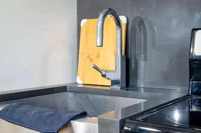 a kitchen counter with a sink and a cutting board at Suite 24 - East Harlem, Manhattan by Monthier in New York