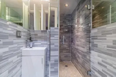 a bathroom with a sink and a glass shower at Suite 24 - East Harlem, Manhattan by Monthier in New York