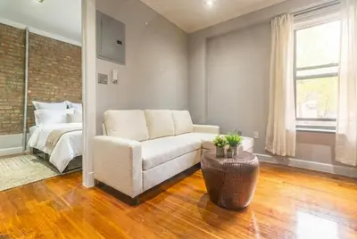 a living room with a couch and a bed at Suite 24 - East Harlem, Manhattan by Monthier in New York