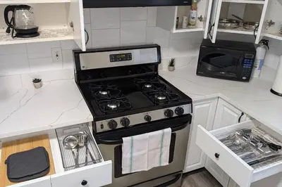 a kitchen with a stove and a microwave at Spacious 2BR - 15m to Times Square - FREE Parking in North Bergen