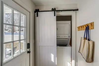 a door to a kitchen with a washer and dryer at Lakefront Escape with Dock! Hudson Valley Home in Hillsdale