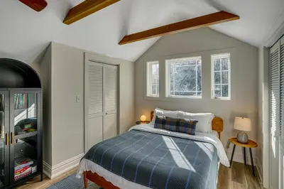 a bedroom with a bed with a blue blanket at Lakefront Escape with Dock! Hudson Valley Home in Hillsdale