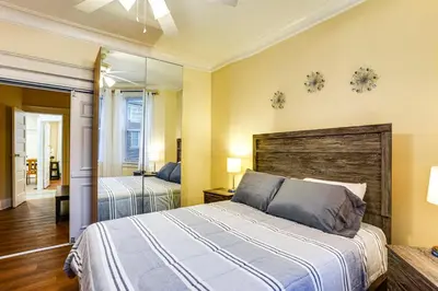 a bedroom with a bed and a mirror at Easy NYC Access! Gateway Region Apartment with Yard in West New York