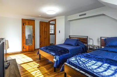 a bedroom with two beds with blue comforters at Stratford Family Home Near Forest and Historic Sites in Stratford