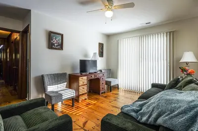 a living room with a couch and a tv at Stratford Family Home Near Forest and Historic Sites in Stratford