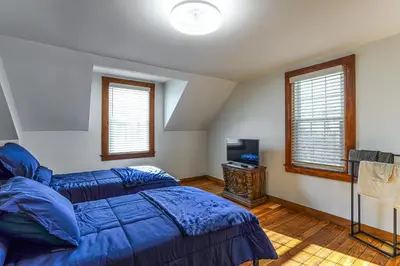 a bedroom with two beds and a tv in it at Stratford Family Home Near Forest and Historic Sites in Stratford