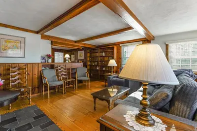 a living room with a couch and a table with a lamp at Stratford Family Home Near Forest and Historic Sites in Stratford