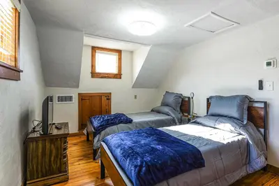 a bedroom with two beds and a flat screen tv at Stratford Family Home Near Forest and Historic Sites in Stratford