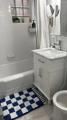 a bathroom with a tub and a sink and a toilet at Serene Studio in Brooklyn Heights in Brooklyn