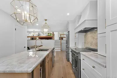 a white kitchen with a sink and a counter at Renovated Retreat with Heated Pool in Redding
