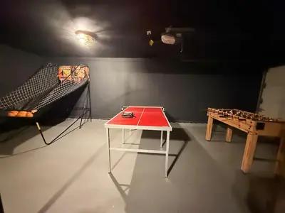 a room with a ping pong table and a bed at Renovated Retreat with Heated Pool in Redding