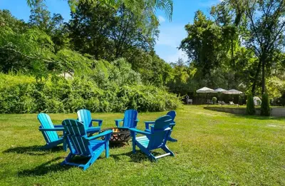 a group of blue chairs sitting in the grass at Renovated Retreat with Heated Pool in Redding