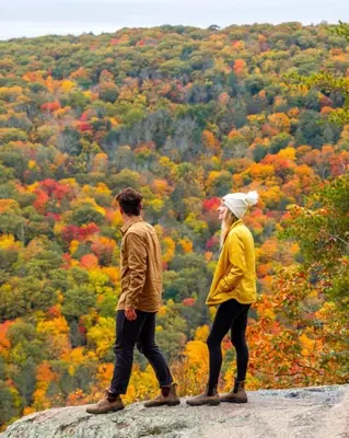 two people standing on top of a rock looking at a forest at Renovated Retreat with Heated Pool in Redding